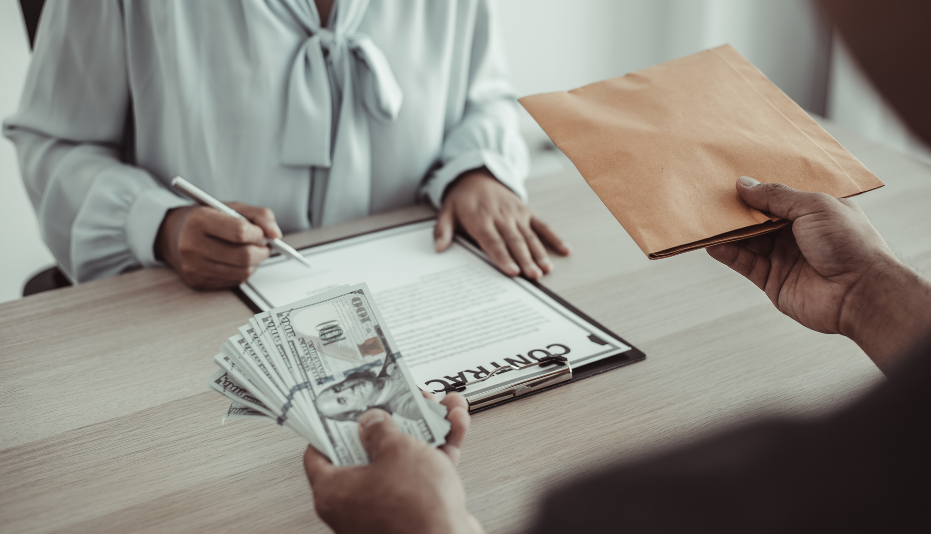 Businessperson Bribing an Employee to Sign a Contract